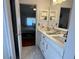 Bright bathroom featuring double sinks, quartz countertops and ample storage, adjacent to the main bedroom at 11227 Summer Star Dr, Riverview, FL 33579