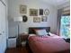Cozy bedroom with wood floors, stylish wall art, and bright window with a serene view at 11227 Summer Star Dr, Riverview, FL 33579
