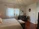 Comfortable bedroom featuring a large window and a dedicated vanity area with a decorative mirror at 11227 Summer Star Dr, Riverview, FL 33579