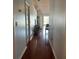 Hallway with hardwood flooring leading into the cozy living room with sliding glass door at 11227 Summer Star Dr, Riverview, FL 33579