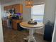 Kitchen with tile flooring, wood cabinets, stainless steel appliances, and a white wood dining table at 11227 Summer Star Dr, Riverview, FL 33579