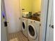 The laundry room offers a washer and dryer with overhead cabinet storage at 11227 Summer Star Dr, Riverview, FL 33579