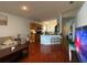 Bright living room with open kitchen and modern breakfast bar with wooden cabinets and stainless steel appliances at 11227 Summer Star Dr, Riverview, FL 33579