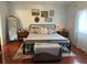 Tranquil main bedroom with a metal frame bed, area rug, and cozy decor for a relaxing retreat at 11227 Summer Star Dr, Riverview, FL 33579