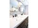 Bathroom with double sinks, quartz countertop, dark wood cabinets, and modern fixtures at 1438 S Hillcrest Ave, Clearwater, FL 33756