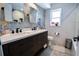 Beautiful bathroom with a double vanity, modern fixtures, decorative tile and a window for natural light at 1438 S Hillcrest Ave, Clearwater, FL 33756