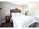 Bedroom featuring a large decorative headboard, decorative pillows, and wood floors at 1438 S Hillcrest Ave, Clearwater, FL 33756