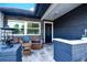 Beautifully landscaped front porch with seating and a modern lamp at 1438 S Hillcrest Ave, Clearwater, FL 33756
