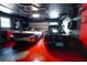 Garage with two sports cars, custom work benches and red epoxy floors at 1438 S Hillcrest Ave, Clearwater, FL 33756
