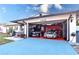 Garage with two sports cars and red epoxy floors at 1438 S Hillcrest Ave, Clearwater, FL 33756