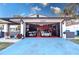 Garage with two sports cars, custom work benches and red epoxy floors at 1438 S Hillcrest Ave, Clearwater, FL 33756