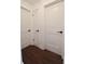 Bright hallway features three paneled doors with modern black hardware and dark hardwood floors at 1438 S Hillcrest Ave, Clearwater, FL 33756