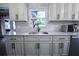 Stylish kitchen with white cabinets, modern hardware, quartz countertops, and a window at 1438 S Hillcrest Ave, Clearwater, FL 33756