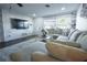 Bright living room features a large sectional sofa, accent wall and a decorative area rug at 1438 S Hillcrest Ave, Clearwater, FL 33756