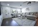 Bright living room featuring a large sectional sofa, area rug, and stylish decor at 1438 S Hillcrest Ave, Clearwater, FL 33756