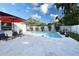 Inviting backyard pool with lounge chairs and manicured landscaping creating a private oasis at 1438 S Hillcrest Ave, Clearwater, FL 33756