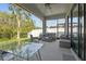 Relaxing outdoor patio featuring modern furniture, ceiling fan and screened in enclosure at 15170 Aviles Pkwy, Odessa, FL 33556