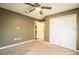 Bedroom featuring a ceiling fan, neutral walls, closet, and carpeted flooring at 16616 Magnolia Reserve Pl, Wimauma, FL 33598