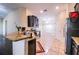 Well-lit kitchen featuring granite countertops, stainless steel appliances, and tile flooring at 16616 Magnolia Reserve Pl, Wimauma, FL 33598