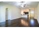 Open-concept living room showcases hardwood floors and seamless flow into the kitchen at 16616 Magnolia Reserve Pl, Wimauma, FL 33598