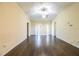 Bright living room with hardwood floors, a ceiling fan, and sliding glass doors at 16616 Magnolia Reserve Pl, Wimauma, FL 33598