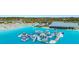 Aerial view of a water park, complete with inflatable climbing toys and a pristine blue lagoon at 16815 Trite Bend St, Wimauma, FL 33598