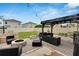 Spacious backyard featuring a pergola, fire pit, and comfortable seating for outdoor enjoyment at 16815 Trite Bend St, Wimauma, FL 33598