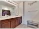 Bathroom with a double sink vanity, large mirror, and shower with curtain at 16815 Trite Bend St, Wimauma, FL 33598