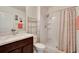 Bathroom featuring modern vanity, toilet, shelving, and shower with stylish curtain at 16815 Trite Bend St, Wimauma, FL 33598
