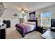 Cozy bedroom with a comfortable purple bed, ceiling fan and plenty of natural light at 16815 Trite Bend St, Wimauma, FL 33598