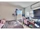 Comfortable bedroom featuring a window with natural light and personal touches at 16815 Trite Bend St, Wimauma, FL 33598