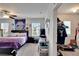 Bedroom featuring a queen-sized bed with purple bedding and a ceiling fan at 16815 Trite Bend St, Wimauma, FL 33598