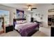 Bright bedroom with a cozy bed, ceiling fan, and closet access at 16815 Trite Bend St, Wimauma, FL 33598