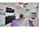 Bedroom with a ceiling fan, mounted TV, and modern furnishings at 16815 Trite Bend St, Wimauma, FL 33598