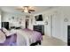 Bedroom with mounted TV, desk, and closet access with ceiling fan at 16815 Trite Bend St, Wimauma, FL 33598