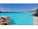 A resort-style pool with clear turquoise water and multiple kayaks on the shore at 16815 Trite Bend St, Wimauma, FL 33598