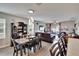 Open-concept dining and living room with modern lighting and stylish decor at 16815 Trite Bend St, Wimauma, FL 33598