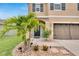 Inviting front entrance with a well-maintained lawn, a welcoming walkway, and a meticulously landscaped garden at 16815 Trite Bend St, Wimauma, FL 33598