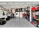 Spacious garage with ample storage, shelving, and room for multiple vehicles, plus a bonus seating area at 16815 Trite Bend St, Wimauma, FL 33598