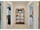Hallway on second floor with shelving between bedrooms at 16815 Trite Bend St, Wimauma, FL 33598