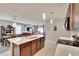 Open-concept kitchen with a large center island and views to the living spaces at 16815 Trite Bend St, Wimauma, FL 33598