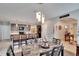 Open layout with kitchen island, bar seating, and elegant pendant lighting at 16815 Trite Bend St, Wimauma, FL 33598