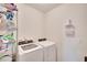 Bright laundry area with modern white appliances and shelving for storage solutions at 16815 Trite Bend St, Wimauma, FL 33598