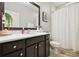 Bathroom with marble countertop, dark cabinets, and framed mirror at 1796 Tonka Ter, Wesley Chapel, FL 33543