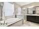 Well-lit bathroom features a soaking tub, glass-enclosed shower, and modern vanity at 1796 Tonka Ter, Wesley Chapel, FL 33543