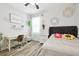 Stylish bedroom features desk, wooden floors, and eclectic wall decor at 1796 Tonka Ter, Wesley Chapel, FL 33543