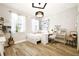 Bright bedroom with wood floors, large windows, and a white modern desk at 1796 Tonka Ter, Wesley Chapel, FL 33543