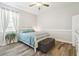 Serene bedroom features neutral tones, natural light, and wood-look flooring at 1796 Tonka Ter, Wesley Chapel, FL 33543