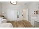 Bedroom featuring wood floor, white closet doors and views to other rooms at 1796 Tonka Ter, Wesley Chapel, FL 33543