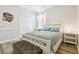 Charming bedroom boasts a white bed frame, soft blue bedding, and wood-look floors at 1796 Tonka Ter, Wesley Chapel, FL 33543